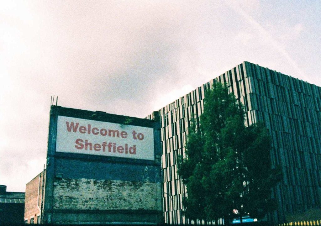 Half frame image of Welcome to Sheffield, Eyre Street on expired, cross-processed Kodak Ektachrome film
